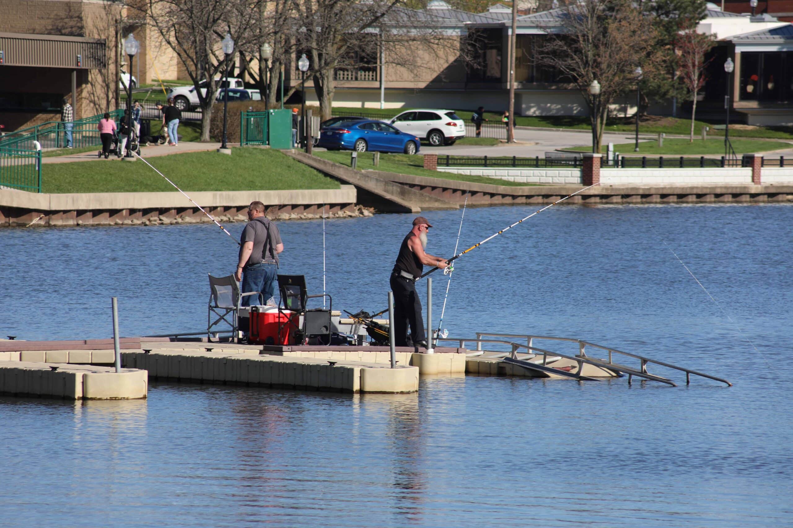 Friends take every advantage of the mid outbreak of pleasant weather to do some fishing off of the docks at Festival Park on Lake George's North shore.